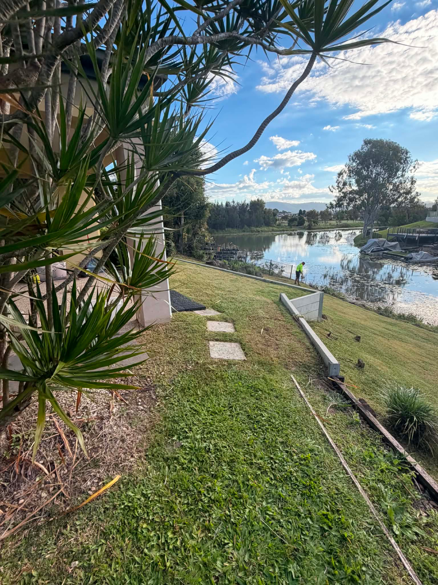 Lakeside lawn being professionally maintained on the Gold Coast